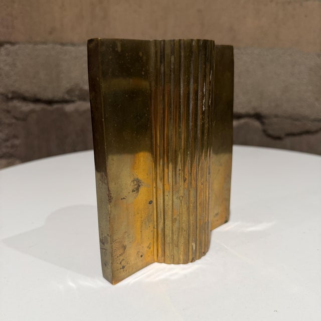 For your consideration, a mid-century modern sculptural object, likely a brass bookend or decorative sculpture vase...