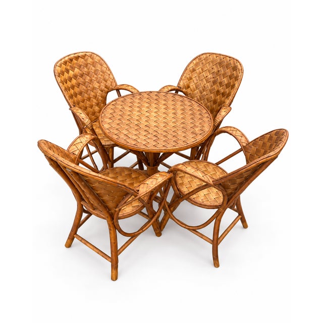 Vintage retro rattan and bamboo lounge set with 4 armchairs and 1 matching round table. Woven rattan, warm tones. Table...