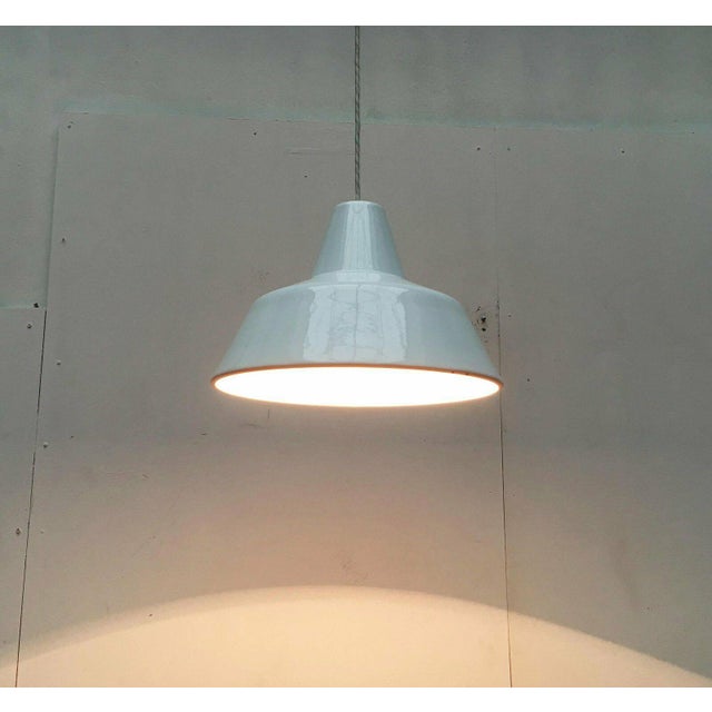 A simple white enamel pendant light from the danish manufacturer louis poulsen. Also known as an enamel fixture or...