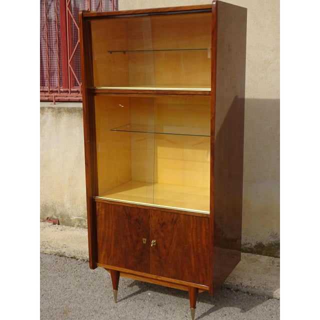A high-quality display cabinet from the 1950s, made by Maison Capelle in Montauban (82), France. The cabinet is crafted...