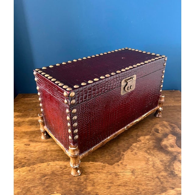 Striking vintage trunk-style decorative box, finished in richly textured faux crocodile leather with deep burgundy tones...