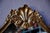 Gilded and lavishly ornamented, this Baroque mirror reflects the somewhat theatrical elegance of the Louis XV style. Its...