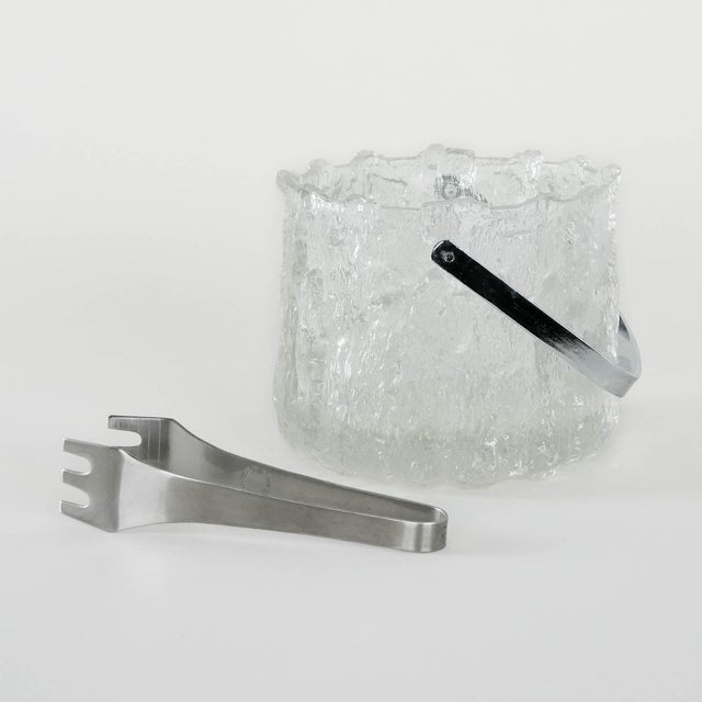 An ice bucket manufactured in the 1970s by the renowned Swedish manufacturer Pukeberg. A stylish ice bucket made of...