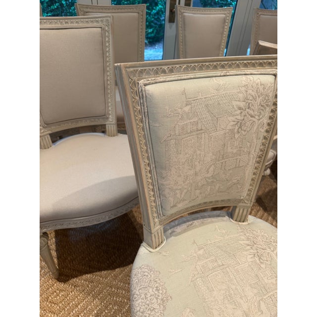 A set of ten Louis XVI style painted side chairs, each with a tapered rectangular upholstered back above a tight...