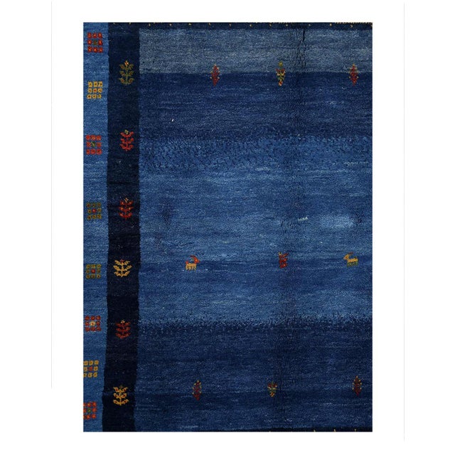 Gabbeh rugs are made by the nomadic Qashqai tribes of southern Iran. They are rough cut and long piled rugs of rich color...