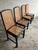 Elegant set of four vintage dining chairs from the 1980s, featuring a black lacquered wooden frame combined with natural...