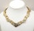 This is part of Chairish’s Costume Jewelry assortment. 1970s Modernist goldtone rough look v center link necklace with...