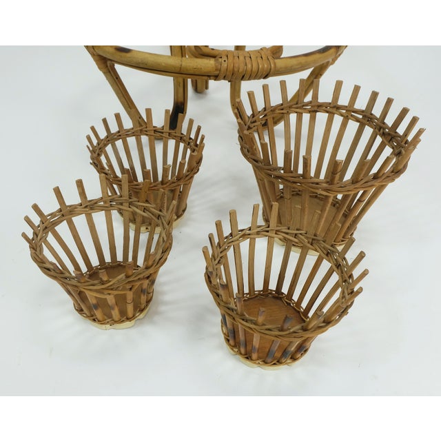 Very beautiful and decorative 1950s to 1960s plant stand. Made of bamboo and rattan. 4 removable inserts. The inserts have...