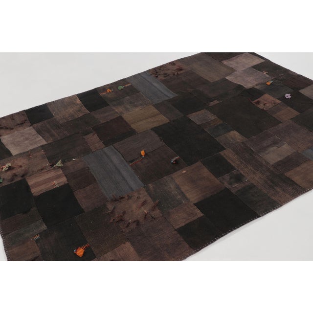 Handwoven in wool and cotton and dating to circa 1950–1960, this vintage 6x8 Turkish kilim rug features a rich patchwork...