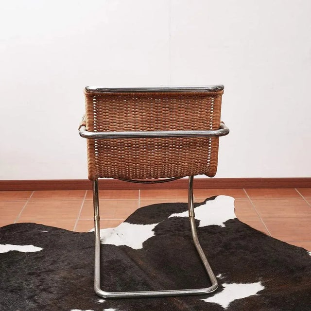 Mr20 armchair in wicker and chromat metal Height: 81 Width: 55 Depth: 80 Sit Height: 44 This piece is attributed to the...