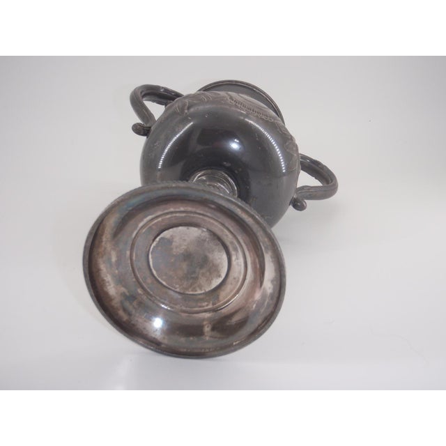 Classic shaped Loving Cup in tarnished German Silver. The front and back side are identical engraved flowers with leaves...