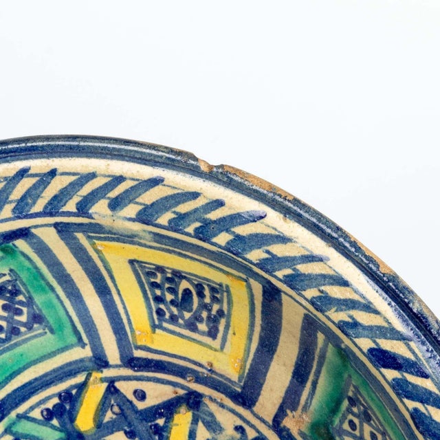 A beautiful handpainted Fes ceramic platter or bowl brightly colored in blue, aqua, and yellow. Featuring stripes, dots, a...