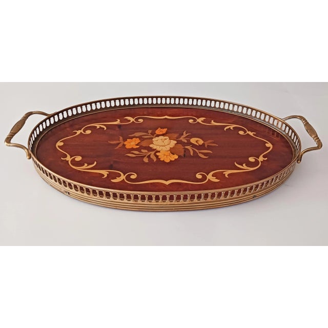 Mid-Century Italian Marquetry wood & brass oval serving tray. The wood inlay features a floral design in the center of the...