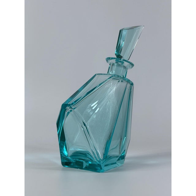 A striking Mid- 20th-century Bohemian crystal decanter, crafted from substantial aqua-blue crystal and distinguished by...