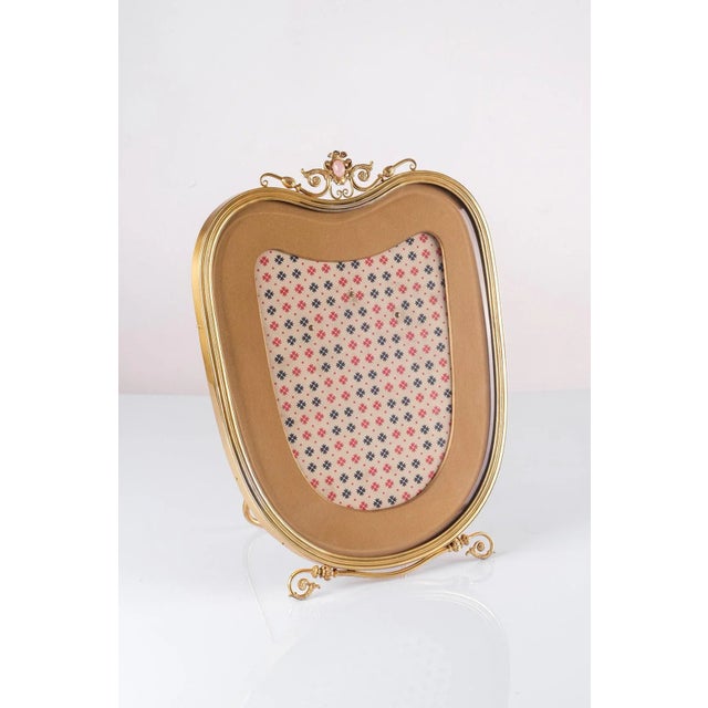 Splendid picture frame in gilded Italian silver with a mounted rose quartz gem on top. Manufactured by De Vecchi, Milano...