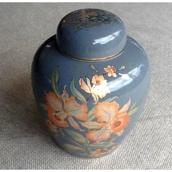 The opulent orange and green orchids outlined in brilliant metallic gold accentuate the glossy gray background of this...