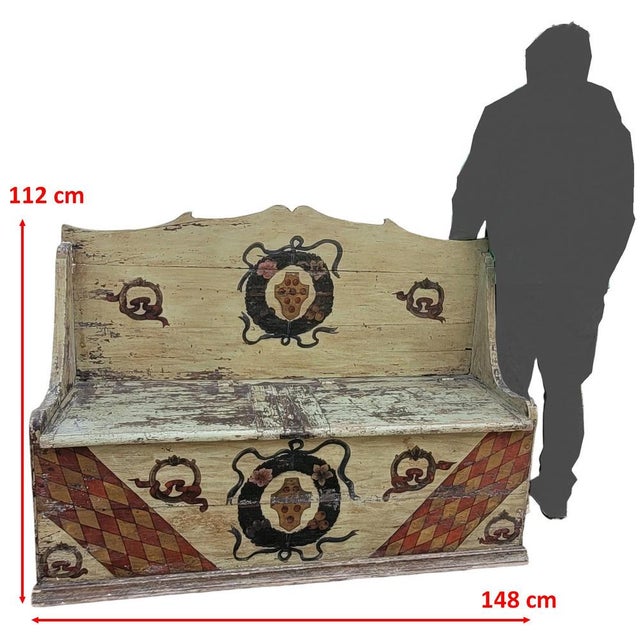 Large high-backed bench with storage compartments, made of light green lacquered wood, the seat forming two chests. The...
