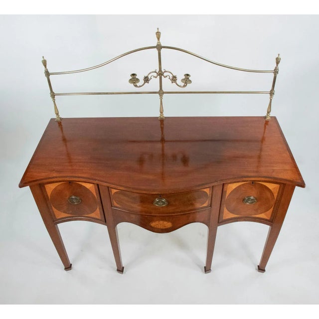 This exquisite sideboard, crafted circa 1790, exemplifies the elegance of the Hepplewhite style, renowned for its graceful...