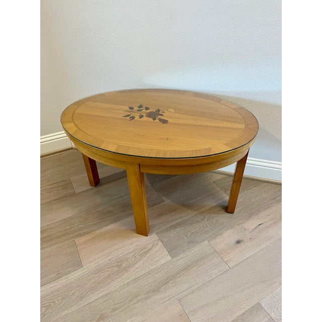 A elegant vintage German Biedermeier style sycamore maple floral inlaid low table. circa 1960 Born in the mid-20th...