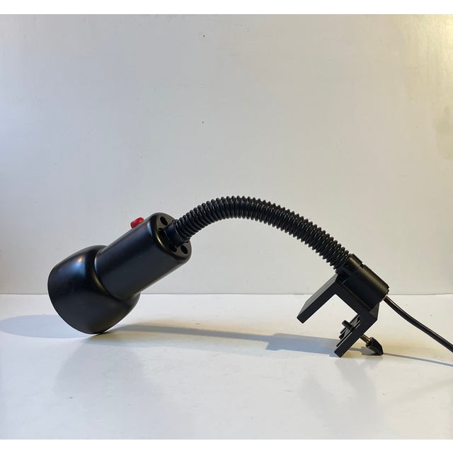 Multi-adjustable Wall light with clamp mount. Everything is black besides the red on/of switch and It is called black...