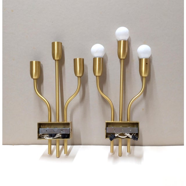 These brass wall lights are attributed to Gaetano Sciolari for form and style. No label. These wall lights are in very...