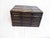 This leather box, impressed with gold-leaf, trimmed in bamboo is lined with paper.