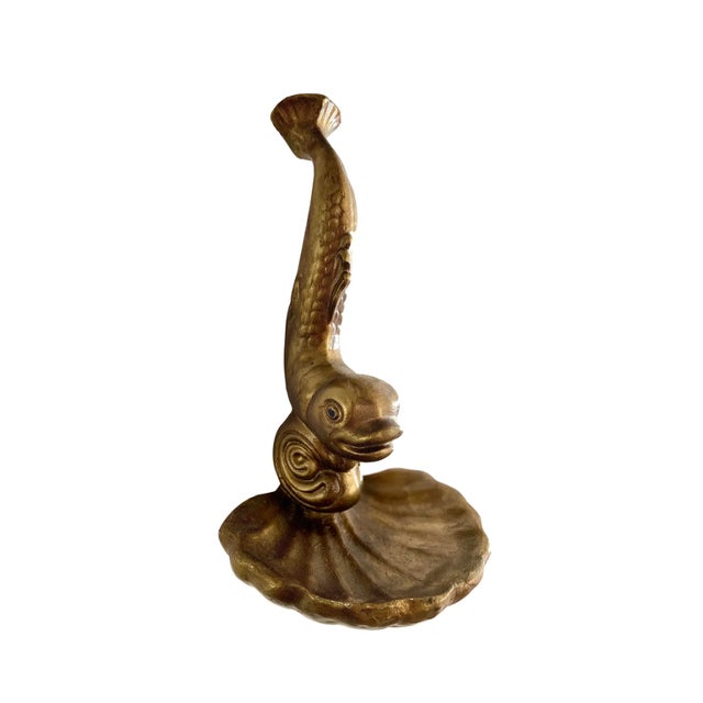 A striking vintage gold-toned koi fish wall shelf with an expressive, sculptural design. The piece features a stylized koi...
