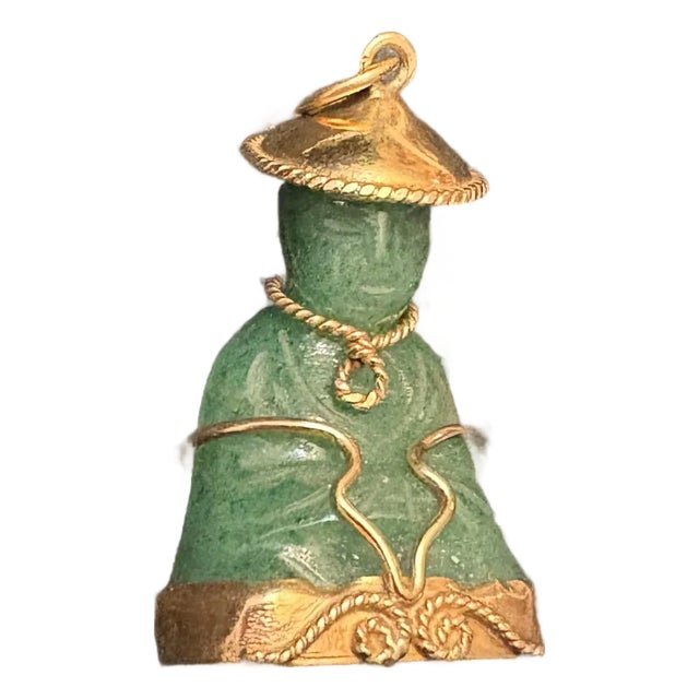 Wonderful ornate carved Jade Buddha charm or pendant encased in 14 karat gold setting wire wrapping with a gold hat. The...