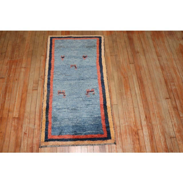 A late 20th century one of a kind persian gabbeh blue folk art rug that has been Professionally Cleaned and restored . it...