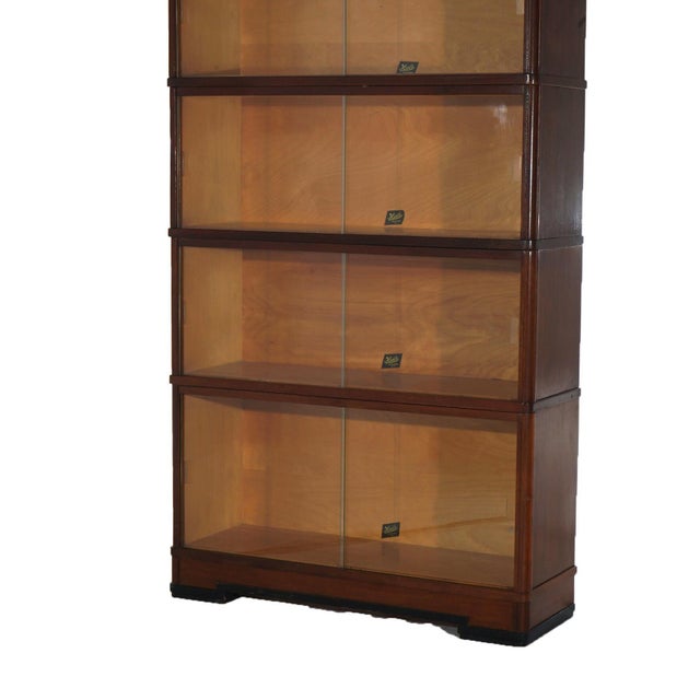 An antique Art Deco barrister bookcase by Hale offers mahogany construction with four stacks, each having pullout glass...
