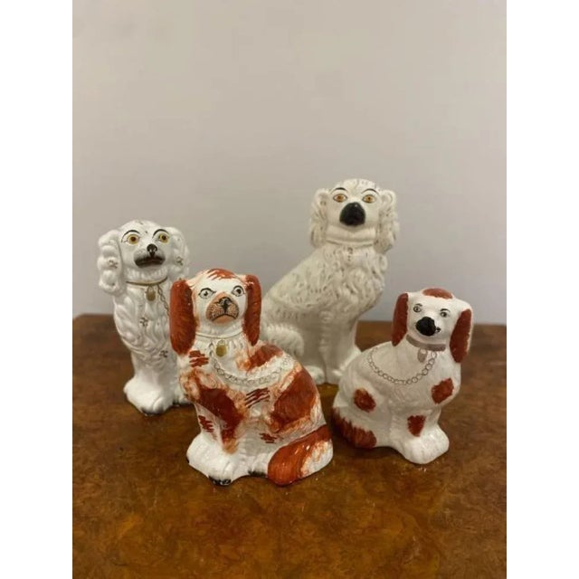 Collection of four antique quality Staffordshire hand painted Spaniels. Four quality Staffordshire spaniel dogs seated in...