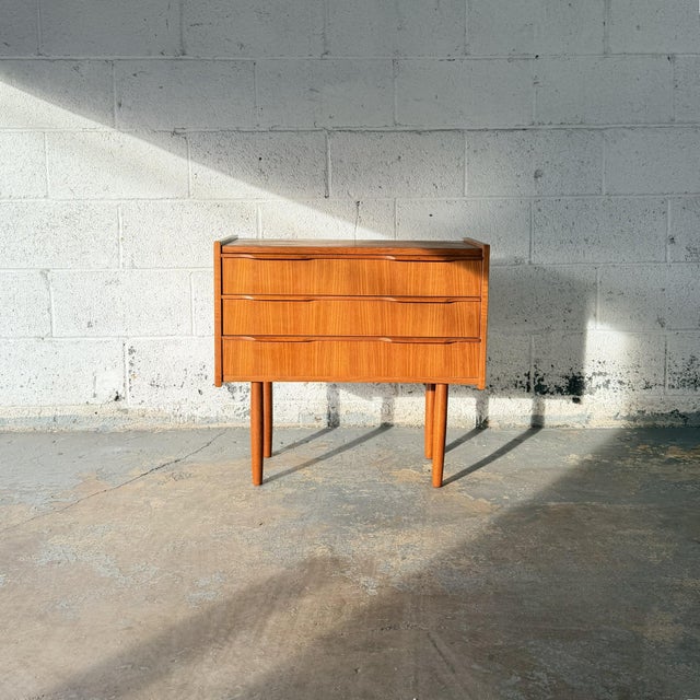 A vintage Danish teak three-drawer commode by Ejsing Møbelfabrik, dating to the 1960s. The case is defined by three wide...