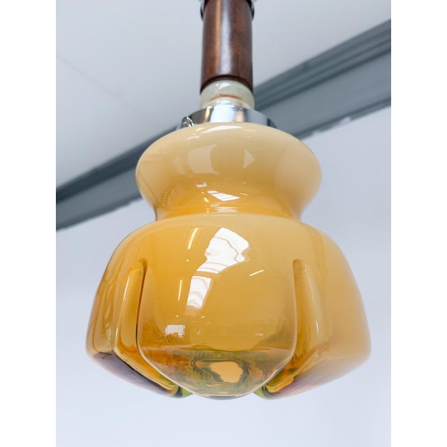 Unique Italian Murano glass pendant lamp in the style of Mazzega, dating from the 1960s. The glass shade, featuring warm...