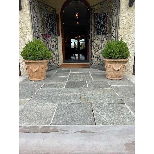 A large Tuscan style embossed terracotta planter having decorative festoons, swags and cherub faces. Two are available but...