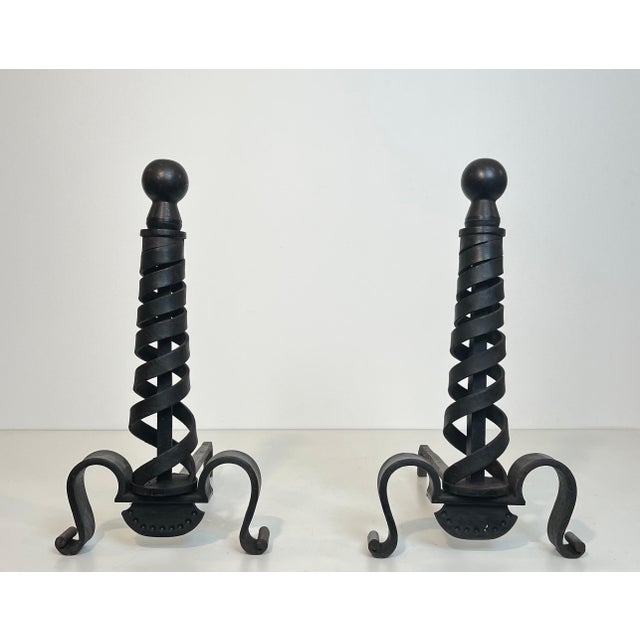 This pair of modernist andirons is made of cast iron and wrought iron. It is a French work by Raymond Subes. Circa 1940.
