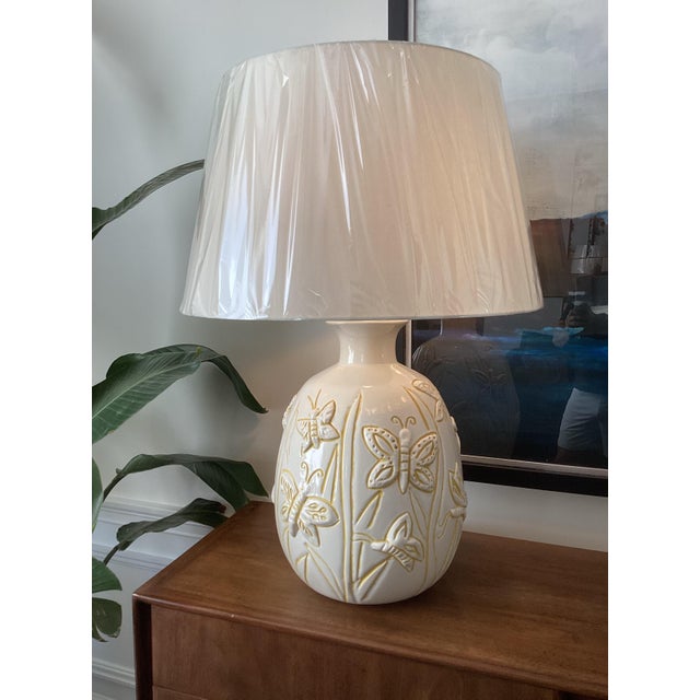 Overscale vintage ceramic table lamp featuring a beautifully sculpted, rounded form with raised butterfly and botanical...
