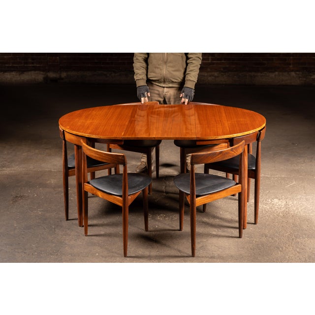 Expandable round dining table with matching set of seven chairs, designed by Hans Olsen as part of his celebrated...