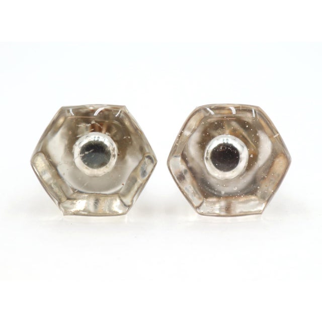 Vintage cabinet or drawer knobs made of clear glass with a hexagon shape and a bullet center. Mounting screws are...
