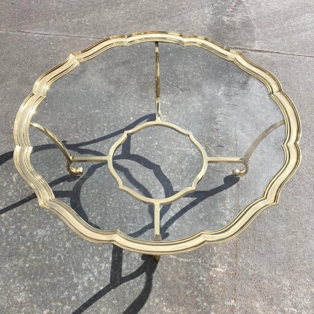 Vintage scalloped brass and glass top scrolled leg coffee table, manufactured in a Italy, by Labarge, circa 1970s.