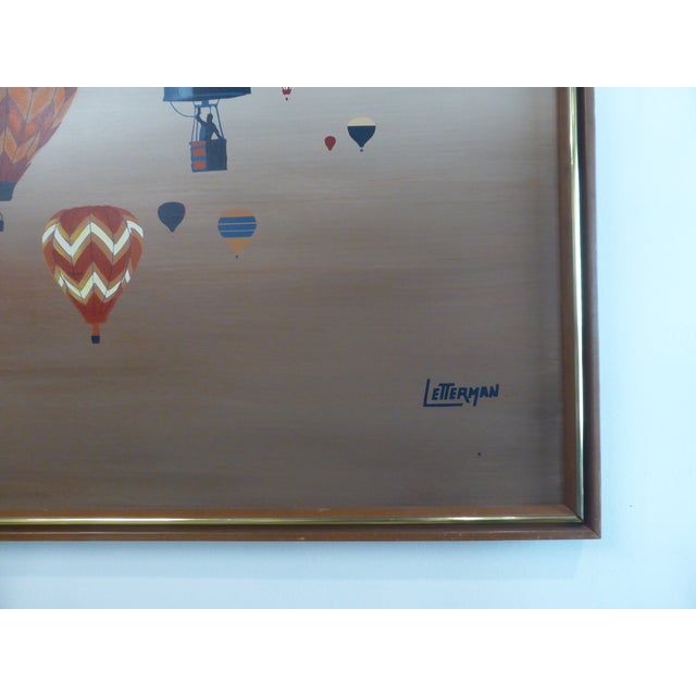 Mid-Century Modern acrylic on canvas painting signed Letterman featuring hot air balloons, where the subject offers a...