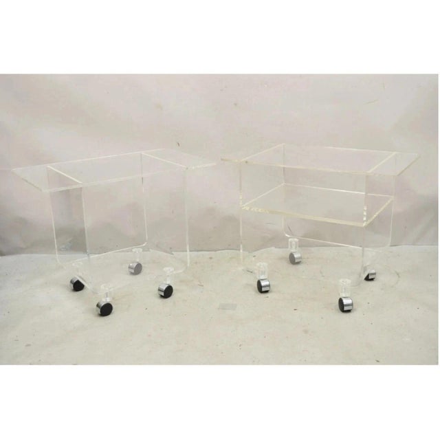 Vintage Clear Lucite Acrylic Mid Century Modern Rolling Side Tables - a Pair. Tables feature a slight variation in style...