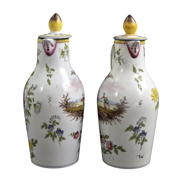 A french marseille faience pair of oil and vinegar cruets, made at veuve perrin circa 1770–1780. Both retain their...