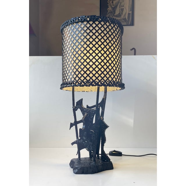 A large sculptural art table light fashioned from reclaimed torch cut welded steel and iron. Entirely black lacquered...