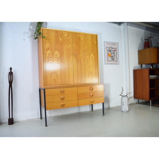 This is a two-part mid-century modern cabinet from the renowned Hellerau workshops in Germany. The design of this cabinet...