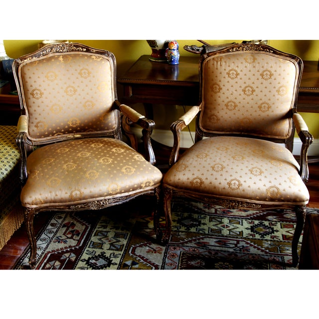 A pair of vintage fauteuil chairs upholstered in a rich brocade fabric that is cool to the touch, but immediately warms-up...