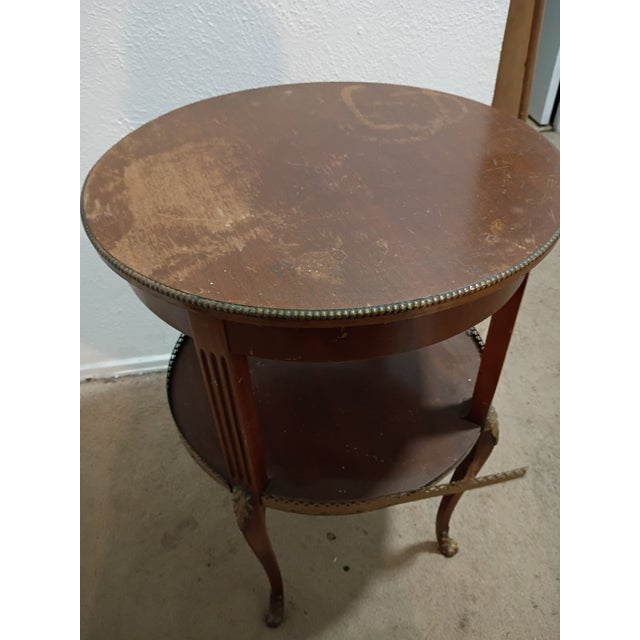 Two-tier round occasional accent table in a Louis XVI style, with brass or bronze mounts, fluted legs 20 x 28