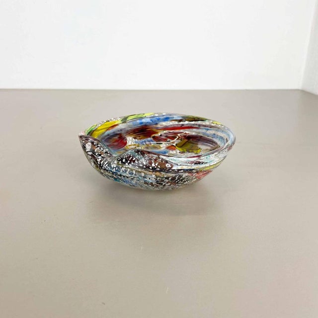 This original glass shell bowl was produced in the 1960s in murano, italy. An elegant muticolor murano glass element...
