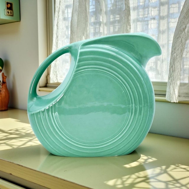 A classic of American industrial design, this original Fiesta “Disc” pitcher showcases the clean modern curves and...