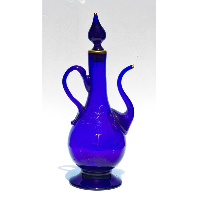 Persian hand blown royal blue glass ewer. Remnants of gold gilding. 19th century.