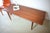 This Danish teak table from the 1960s offers ample space for various favorite items. The elegant legs and tabletop are...